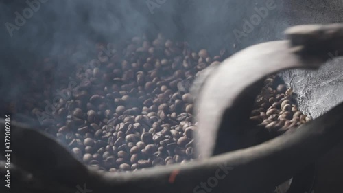 Traditional Indonesian Coffee Making Production Process in Labuan Bajo Flores Indonesia - Green Beans, Roasting, Mashed, Sieving in Slow Motion photo