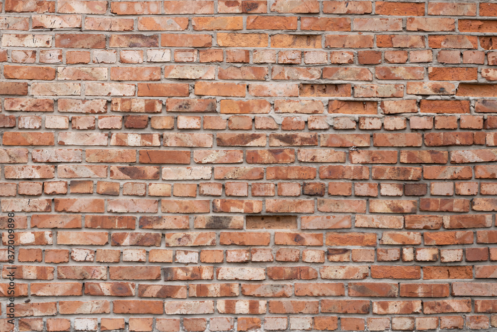 Fototapeta premium Wall of red bricks. Texture or background of bricks.