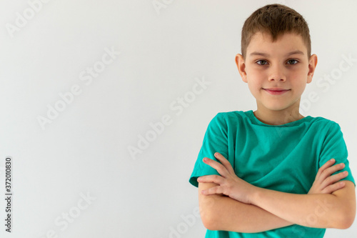 boy on a white background folded his arms on his chest