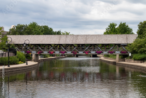 Wooden Covered Bridge over the DuPage River along the Naperville Riverwalk in Suburban Naperville Illinois during Summer © James