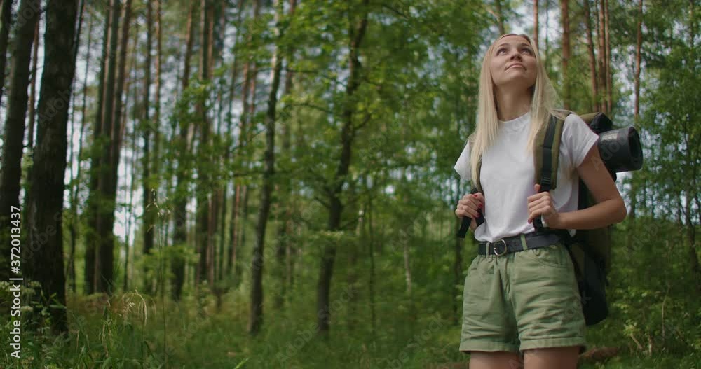 SLow motion: Traveling Happy Caucasian woman with backpack walking on path the tropical forest SLow motion: Traveling Happy Caucasian woman with backpack walking on path the tropical forest