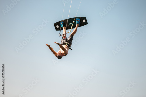 Kitesurfing Kiteboarding action photos man among waves quickly goes