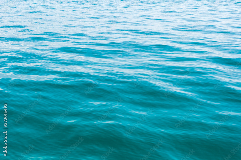 Blurred image of sea water texture in movement. Deep blue and light reflex. Background. Blurred image of sea water texture in movement. Deep blue and light reflex. Background.