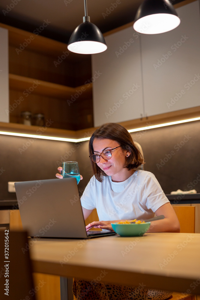 Woman having dinner and working late at home Woman having dinner and working late at home