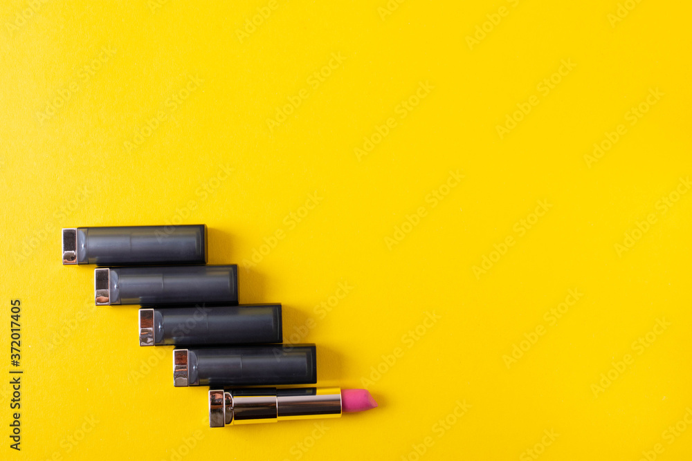 female bright lipsticks on mono colour yellow background female bright lipsticks on mono colour yellow background