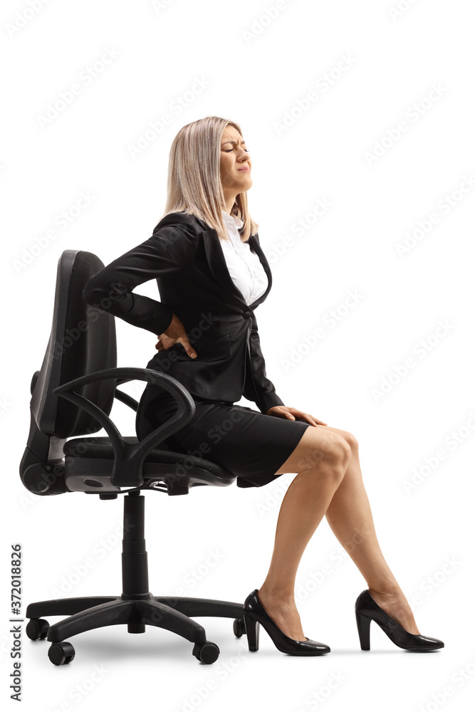 Fototapeta premium Young woman at work with a painful lower back sitting on a chair