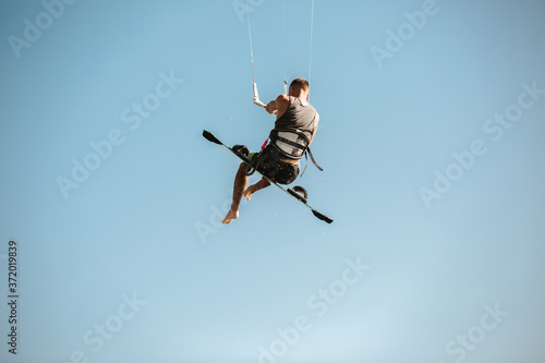 Kitesurfing Kiteboarding action photos man among waves quickly goes