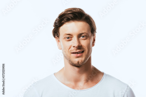 Young man in white t-shirt looking at camera isolated on white