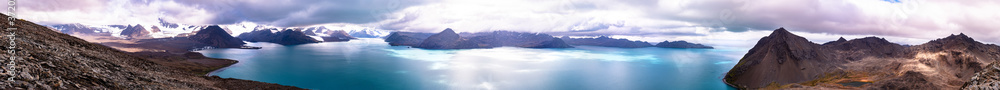 Wide panorama of the beautiful landscape with mountains, sea, and clouds..