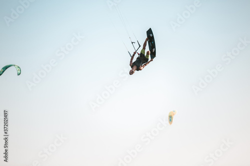 Kitesurfing Kiteboarding action photos man among waves quickly goes