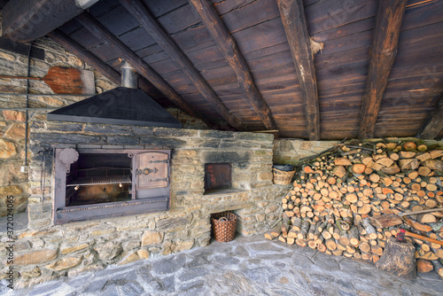 Grill and stone oven next to a woodshed © Luis Vilanova