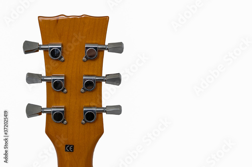 View of back of a guitar neck with six chrome tuners