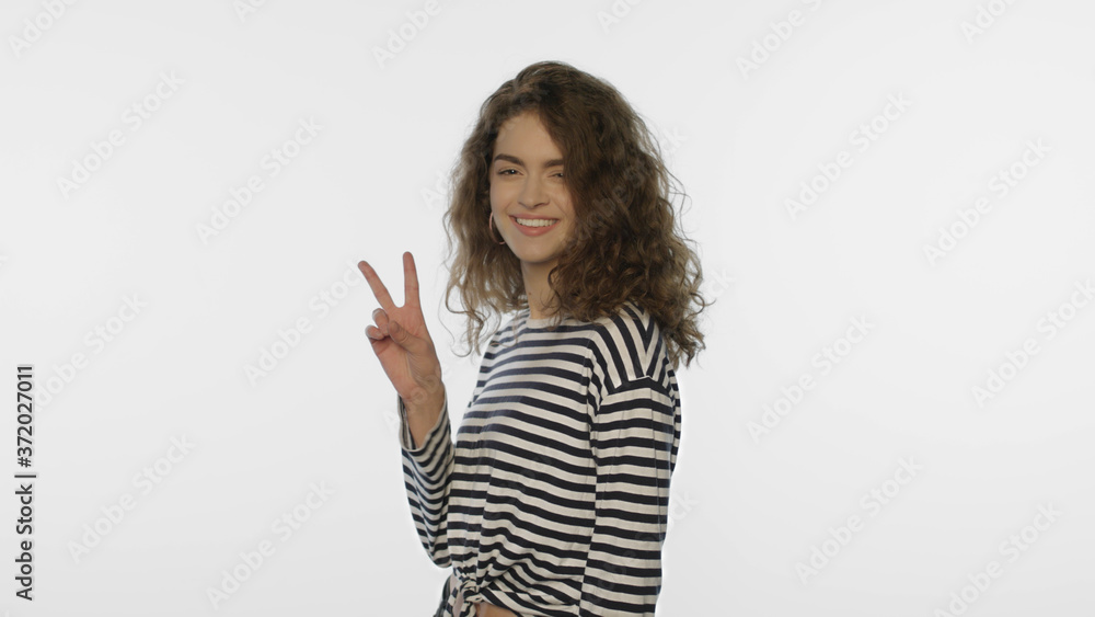 Smiling woman showing v sign on white background. Positive girl show v gesture Smiling woman showing v sign on white background. Positive girl show v gesture