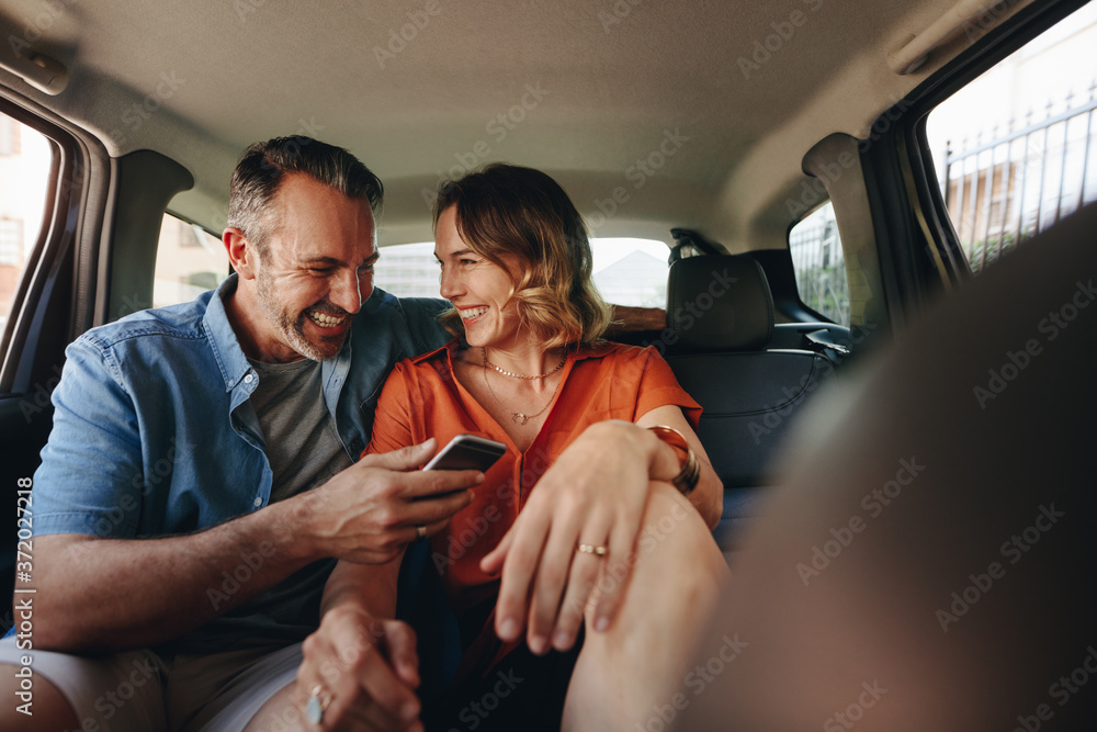 Beautiful couple in back seat of car Beautiful couple in back seat of car