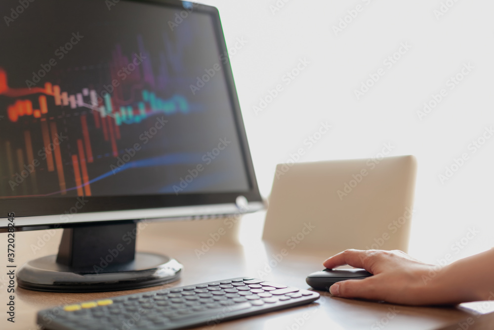 Financial Data Concept:Woman hand pressing mouse to look at financial data.Financial and business graphs, Finance concept on led screen. Financial Data Concept:Woman hand pressing mouse to look at financial data.Financial and business graphs, Finance concept on led screen.