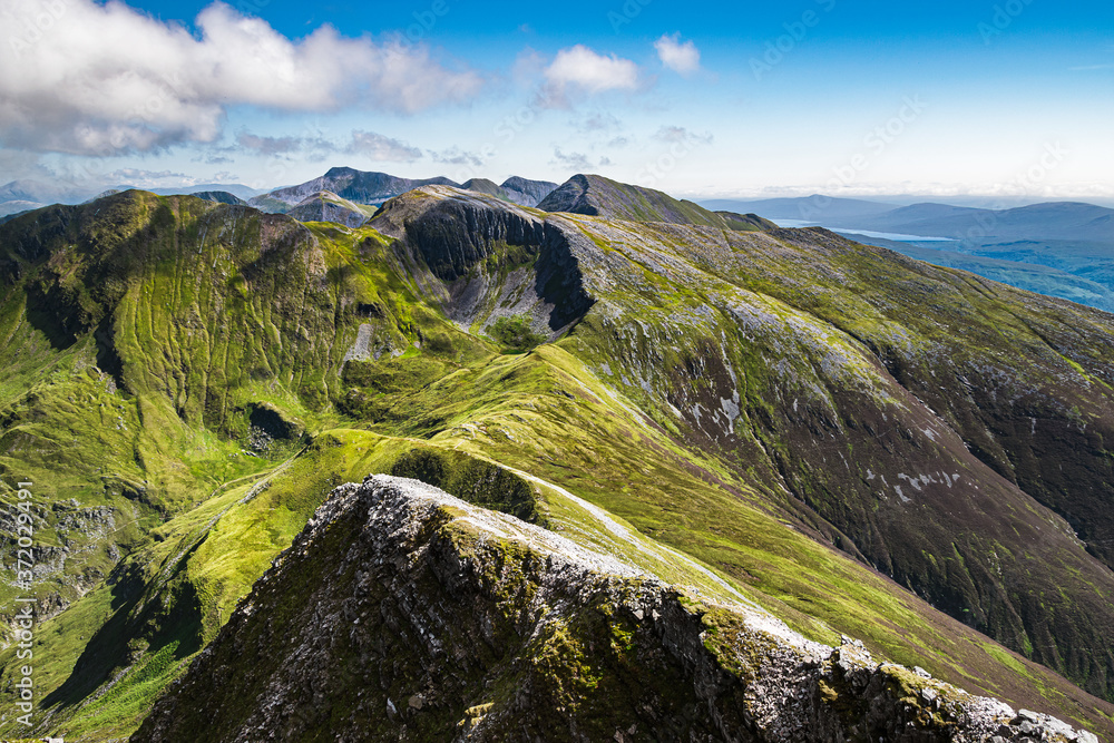 Beautiful Scottish HIghlands landscape. View of the Mamores ridge in Scottish HIghlands on a sunny summer day.