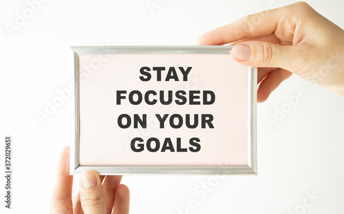 Inspirational quote - Stay focused on your goals. With text message on white paper book.