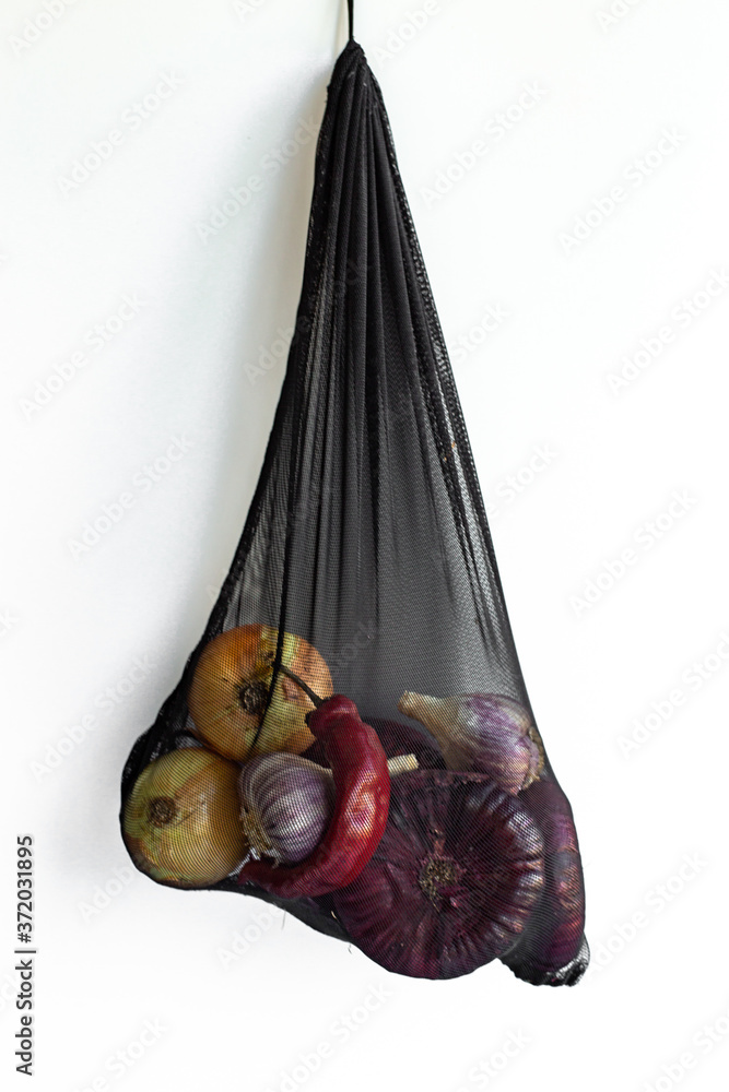 organic vegetables onion and garlic in shopping bag. Eco friendly, zero waste.