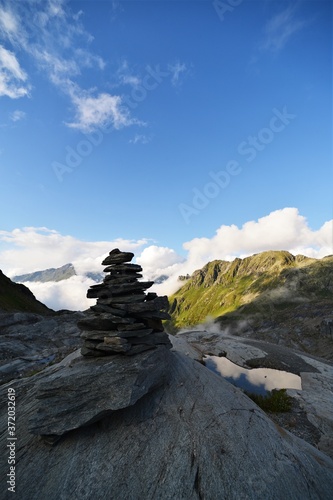 stone tower in the alps in valais in switzerland with a bright blue sky