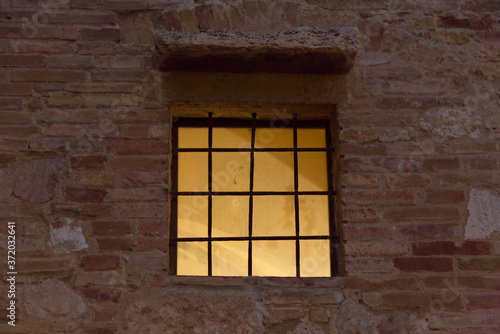 Window of a palace at night in the city of San Gimignano in Tuscany