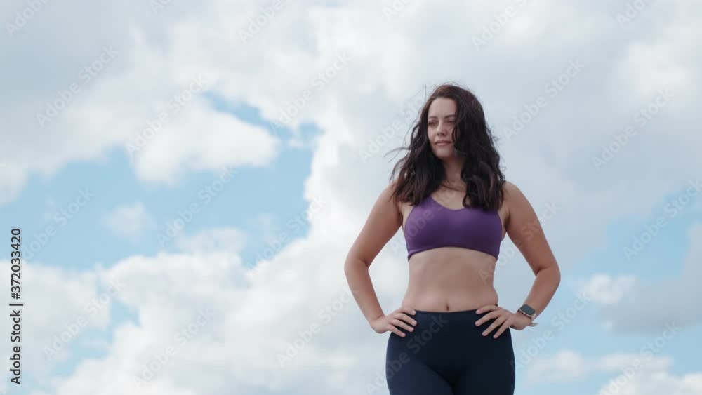 portrait of a sports girl against the background of the sky and clouds portrait of a sports girl against the background of the sky and clouds