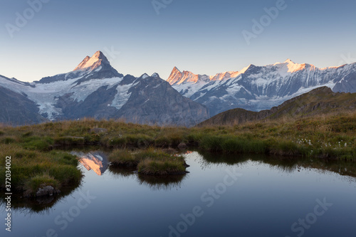 Sunrise view on Bernese range above Bachalpsee lake. Highest peaks Eiger, Jungfrau and Faulhorn in famous location. Switzerland alps, Grindelwald valley. Popular tourist attraction. Europe.  © Michal