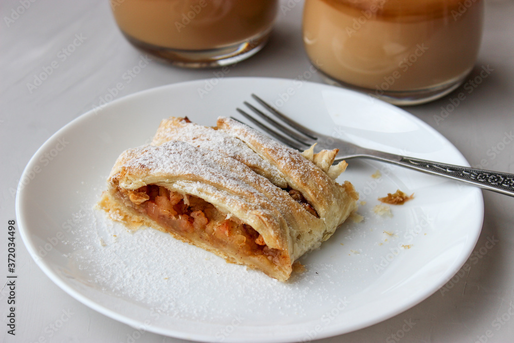 Apple strudel in the form of a pigtail from puff pastry