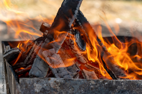 the fire in the grill, burning coals, firewood burn