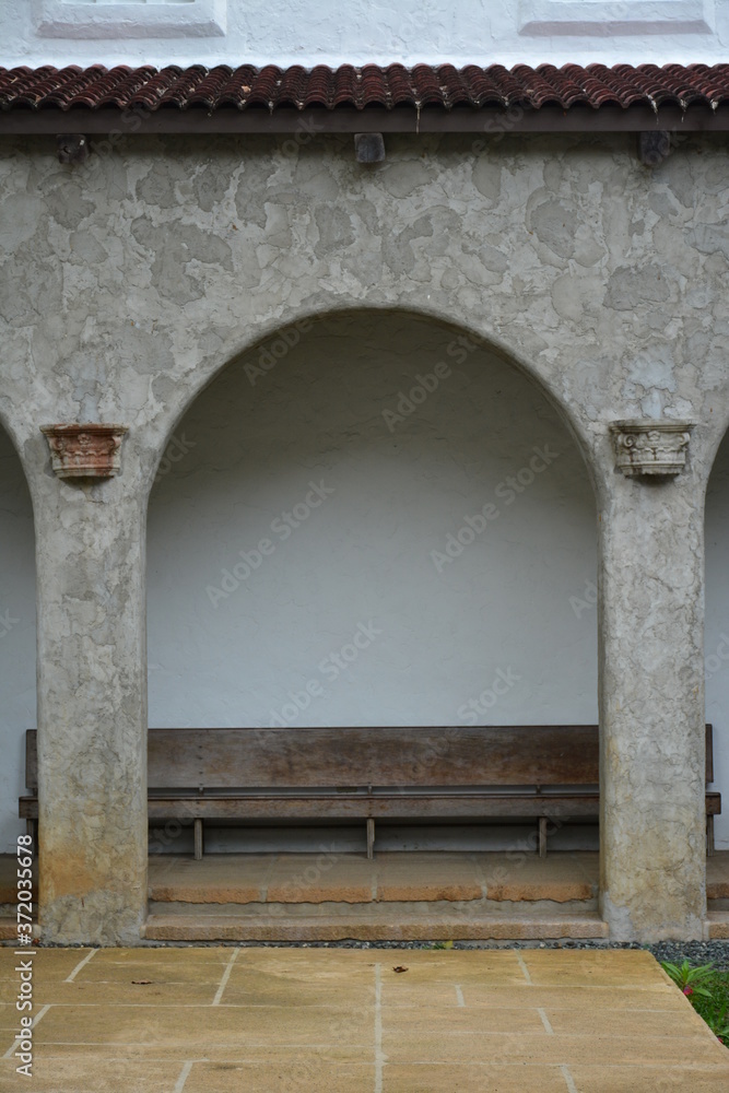 Arch facade wth wooden sitting bench