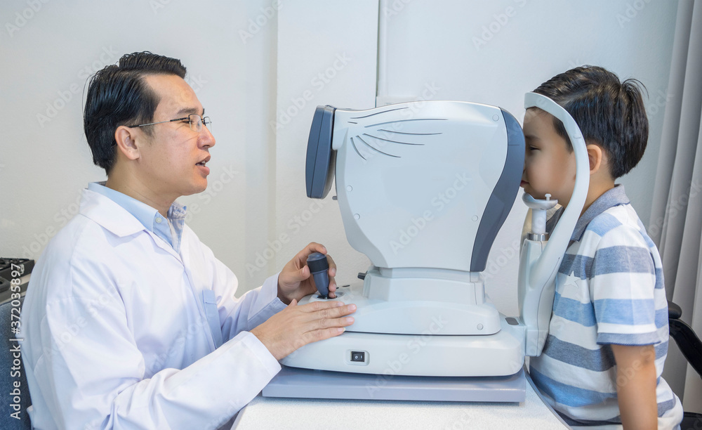 Eye doctor in medical concept.
An eye doctor measured his eyesight for a boy with nearsightedness at an optician. Eye doctor in medical concept.
An eye doctor measured his eyesight for a boy with nearsightedness at an optician.