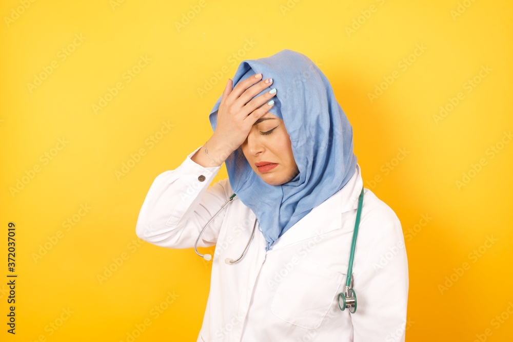 Εκτύπωση καμβά A very upset and lonely Young arab doctor woman wearing medical uniform standing