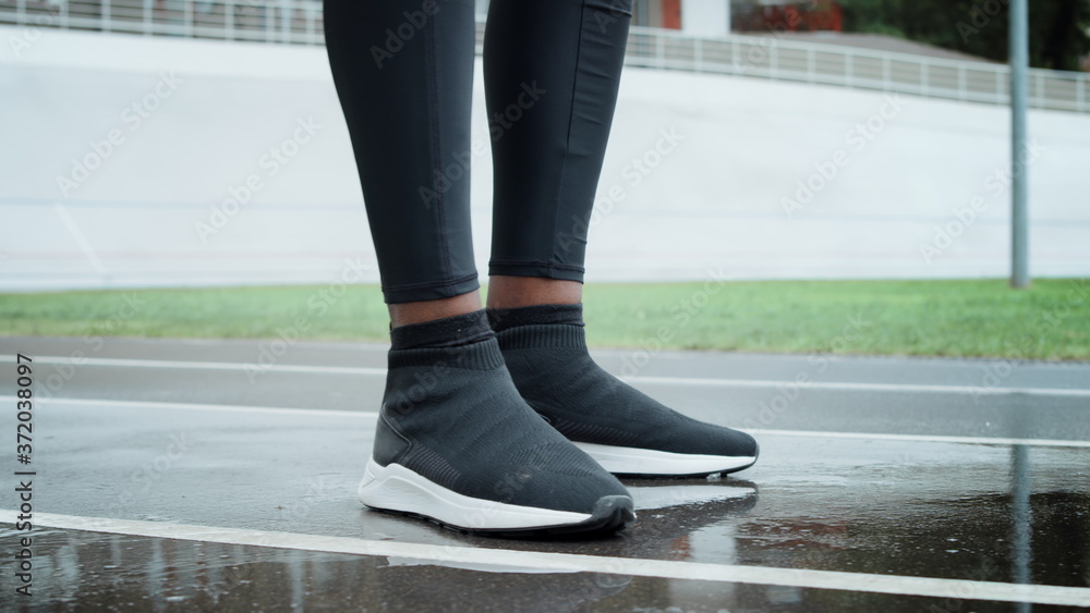 Athlete standing starting to run on racetrack. Jogger running on spot outdoors Athlete standing starting to run on racetrack. Jogger running on spot outdoors