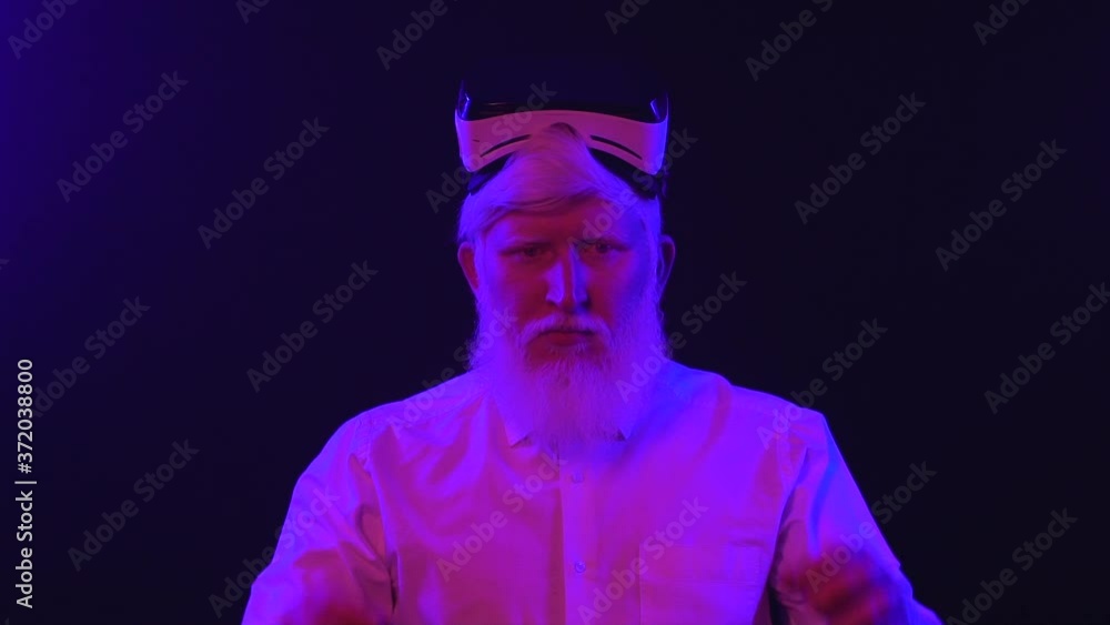 Video of an albino grandfather putting on a new vr set then smiling, isolated on a cool, unique background. Video of an albino grandfather putting on a new vr set then smiling, isolated on a cool, unique background.
