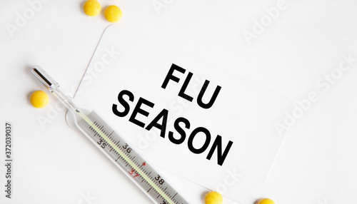 Flu Season written on a paper on table, top view