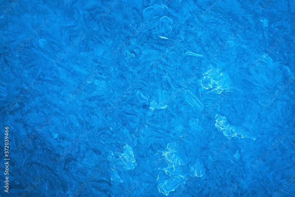 Background of blue cold winter ice. Texture of frozen surface. Frost pattern