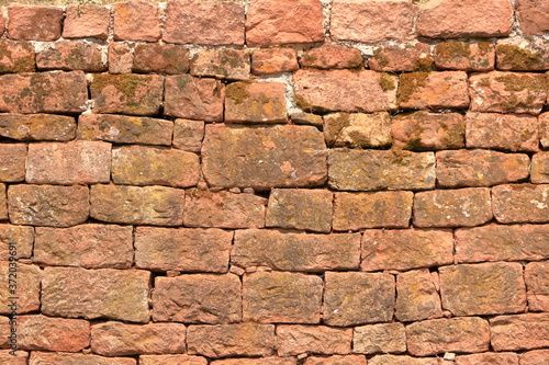 Old brick wall  old texture of red stone blocks closeup