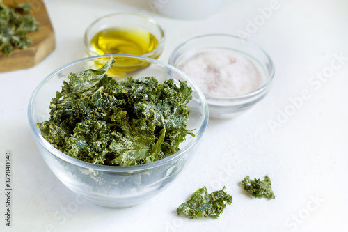 kale chips in glass bowl on white background