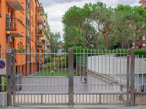 Tela metal gate to access the underground garages of an apartment building with brigh