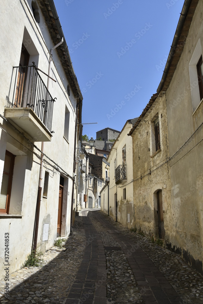 Obraz premium A narrow street among the old houses of Altomonte, a rural village in the Calabria region.