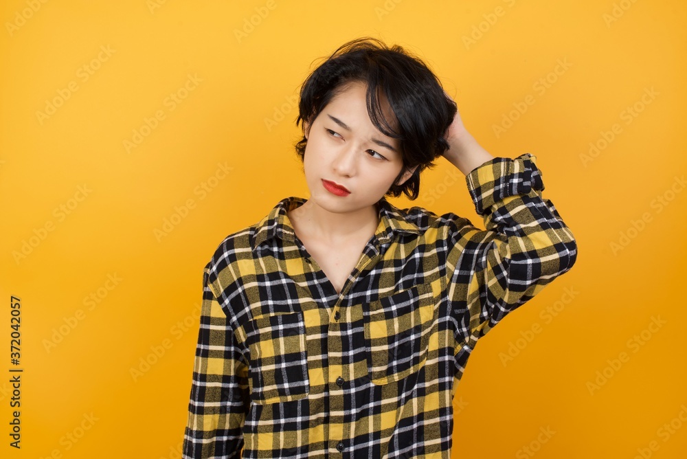 Beautiful business woman wearing elegant shirt over isolated white background confuse and wonder about question. Uncertain with doubt, thinking with hand on head. Pensive concept. Beautiful business woman wearing elegant shirt over isolated white background confuse and wonder about question. Uncertain with doubt, thinking with hand on head. Pensive concept.