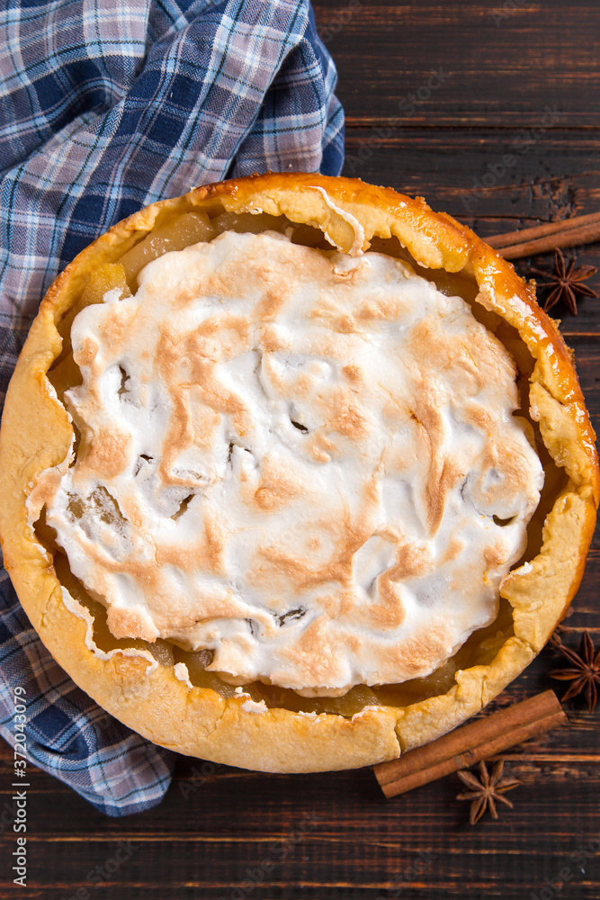 Pear pie with cream, homemade pastries on the wooden table, with spices. Copy space. Pear pie with cream, homemade pastries on the wooden table, with spices. Copy space.