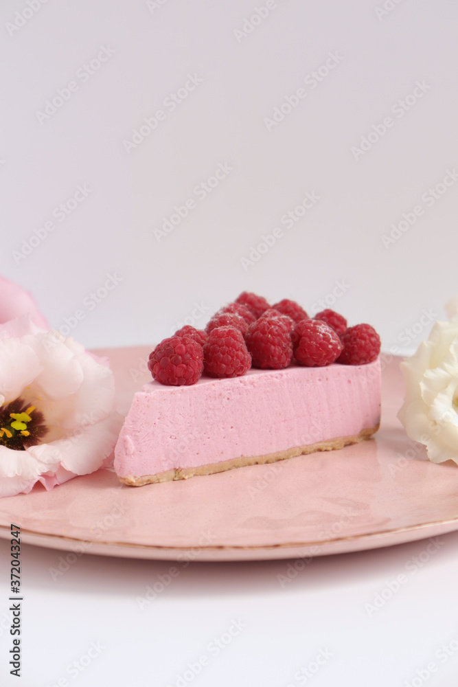 Raspberry cheesecake with berries and fresh flowers on pink plate food photo, sweet cake food photo art, kitchen, menu and restaurant photoshoot Raspberry cheesecake with berries and fresh flowers on pink plate food photo, sweet cake food photo art, kitchen, menu and restaurant photoshoot