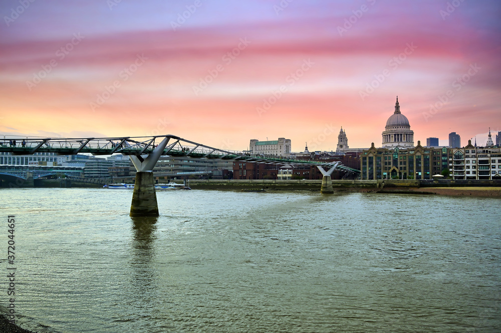 A view across the River Thames at dusk towards St. Paul's Cathedral in London, UK.