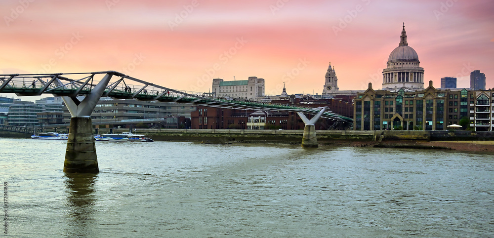 A view across the River Thames at dusk towards St. Paul's Cathedral in London, UK.