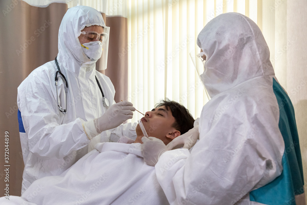 male nurse and doctor wearing ppe suit and facemask perform Coronavirus ...