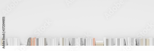 Row of multiple books in front of white wall in room with white floor  literature  book collection or bookshop concept