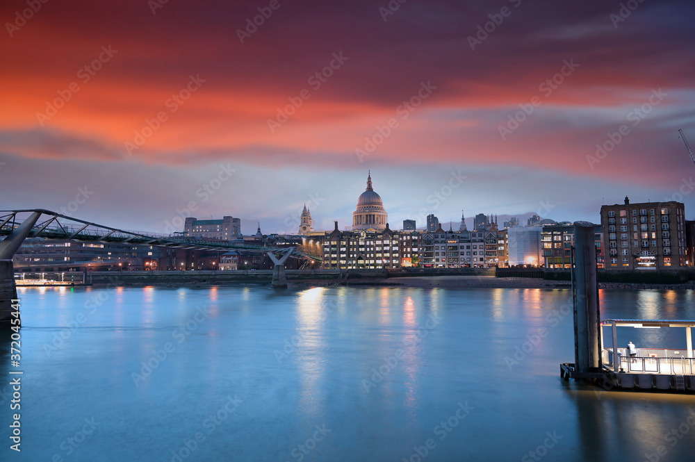 A view across the River Thames at dusk towards St. Paul's Cathedral in London, UK.