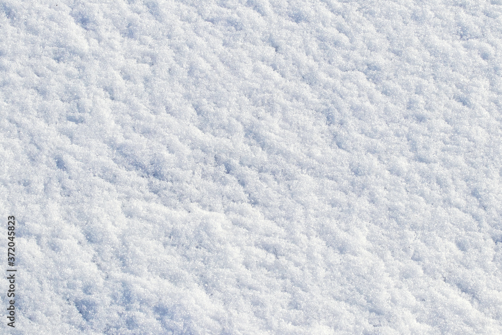 White snow texture in sunny weather. Winter background