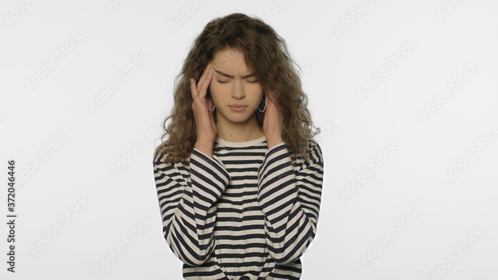 Tired woman headache on white background. Portrait of upset woman touching head Tired woman headache on white background. Portrait of upset woman touching head