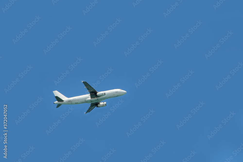Plane flying high in sky. View to air liner flying in blue sky Plane flying high in sky. View to air liner flying in blue sky